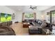 Open living room featuring a large sectional sofa, ceiling fan and large picture window at 5540 E Mercer Ln, Scottsdale, AZ 85254