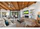 Comfortable living room with a fireplace, wood ceiling beams, and sliding doors to the outdoor space at 5540 E Mercer Ln, Scottsdale, AZ 85254
