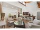 Spacious living room featuring a vaulted ceiling, bar, and multiple seating areas for entertaining guests at 5540 E Mercer Ln, Scottsdale, AZ 85254