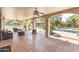 Covered patio overlooking a pool, landscaping, and recreational areas beyond at 5540 E Mercer Ln, Scottsdale, AZ 85254
