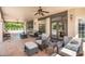 Spacious covered patio featuring terracotta tile, ceiling fans, and comfortable seating at 5540 E Mercer Ln, Scottsdale, AZ 85254