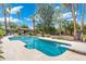 Backyard swimming pool surrounded by lush tropical landscaping and mature shade trees at 5540 E Mercer Ln, Scottsdale, AZ 85254