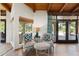 Cozy seating area with armchairs, side table, and view of the outdoor pool area at 5540 E Mercer Ln, Scottsdale, AZ 85254