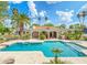 Lush tropical landscaping surrounds the custom swimming pool and spa in the backyard at 5540 E Mercer Ln, Scottsdale, AZ 85254