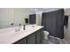 The bathroom features a double vanity, great lighting, and a shower-tub combo at 5805 W Warner St, Phoenix, AZ 85043