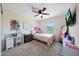 This bedroom is bright and offers natural light, a ceiling fan, and neutral carpet at 5805 W Warner St, Phoenix, AZ 85043