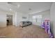 Bonus room with carpeted floors, a comfortable sofa, a window, and plenty of space at 5805 W Warner St, Phoenix, AZ 85043