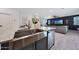 Modern kitchen with granite countertops, stainless steel appliances, a large farm sink, and sleek finishes at 5805 W Warner St, Phoenix, AZ 85043