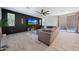 Modern living room with plush sectional sofa, large windows, dark accent wall and tiled floor at 5805 W Warner St, Phoenix, AZ 85043