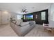 Comfortable living room with neutral walls, plush sectional sofa, large windows, and tiled flooring at 5805 W Warner St, Phoenix, AZ 85043