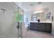 This bright main bathroom offers a walk-in shower, soaking tub, and double vanity at 5805 W Warner St, Phoenix, AZ 85043
