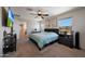 Relax in this main bedroom featuring bright walls, natural light, and a ceiling fan at 5805 W Warner St, Phoenix, AZ 85043