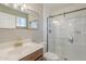 Modern bathroom with a glass-enclosed shower, a vanity with gold hardware, and neutral decor at 643 N 92Nd Pl, Mesa, AZ 85207