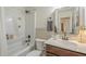 Clean bathroom with a shower-tub combination, vanity, and neutral color scheme offers a relaxing space at 643 N 92Nd Pl, Mesa, AZ 85207