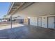 Large covered carport with storage doors, offering convenience and protection at 643 N 92Nd Pl, Mesa, AZ 85207
