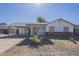 Charming single-story home with a covered front porch and low-maintenance desert landscaping at 643 N 92Nd Pl, Mesa, AZ 85207