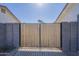 View of the gated entrance to the property between two homes at 643 N 92Nd Pl, Mesa, AZ 85207