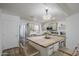 Well-lit kitchen featuring stainless steel appliances, light green cabinets and a functional butcher block island at 643 N 92Nd Pl, Mesa, AZ 85207
