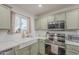 Updated kitchen with stainless steel appliances, light green cabinets, and a bright, inviting atmosphere at 643 N 92Nd Pl, Mesa, AZ 85207