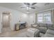 Inviting living room with laminate flooring, and neutral decor with a ceiling fan at 643 N 92Nd Pl, Mesa, AZ 85207