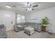Bright living room with laminate floors, a ceiling fan, and comfortable seating at 643 N 92Nd Pl, Mesa, AZ 85207