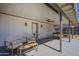 Covered patio with seating and ceiling fan, perfect for outdoor relaxation and entertainment at 643 N 92Nd Pl, Mesa, AZ 85207