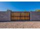 Backyard gate surrounded by a gravel base and cinder block walls at 656 E Mesquite Ave, Apache Junction, AZ 85119