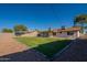 Lush backyard featuring gravel, green grass, and a block wall at 656 E Mesquite Ave, Apache Junction, AZ 85119