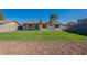 Picturesque backyard view showcasing well-maintained lawn and the home's exterior at 656 E Mesquite Ave, Apache Junction, AZ 85119