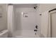 White tiled shower-tub combination with black fixtures and a shower curtain at 656 E Mesquite Ave, Apache Junction, AZ 85119