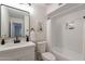 Clean bathroom with a white vanity, modern fixtures, and a shower-tub combination with a white curtain at 656 E Mesquite Ave, Apache Junction, AZ 85119