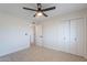 Spacious bedroom with closet, fresh paint, carpet, and door to the hallway at 656 E Mesquite Ave, Apache Junction, AZ 85119