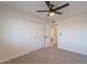 Spacious bedroom featuring a closet, a ceiling fan, and a view of another room at 656 E Mesquite Ave, Apache Junction, AZ 85119