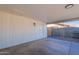 Attached carport featuring concrete floors, a door to the backyard, and ample parking space at 656 E Mesquite Ave, Apache Junction, AZ 85119