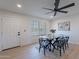 Bright dining room featuring a glass-top table, modern black chairs, and light wood flooring at 656 E Mesquite Ave, Apache Junction, AZ 85119