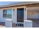 Charming front entrance with modern lighting fixtures and well-kept brick accents at 656 E Mesquite Ave, Apache Junction, AZ 85119