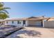 Charming single-story home with a carport, brick accents, desert landscaping and a tidy front yard at 656 E Mesquite Ave, Apache Junction, AZ 85119