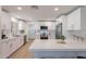 Modern kitchen with stainless steel appliances, breakfast bar, white cabinets and countertops at 656 E Mesquite Ave, Apache Junction, AZ 85119