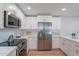 Bright and modern kitchen featuring stainless steel appliances, white cabinets, and light countertops at 656 E Mesquite Ave, Apache Junction, AZ 85119