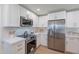Modern kitchen featuring stainless steel appliances, white cabinets, quartz countertops, and stylish hardware at 656 E Mesquite Ave, Apache Junction, AZ 85119
