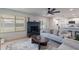 Inviting living room with a painted brick fireplace, large windows, and seamless flow to the kitchen at 656 E Mesquite Ave, Apache Junction, AZ 85119