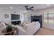 Cozy living room with a painted brick fireplace, large windows, and neutral decor at 656 E Mesquite Ave, Apache Junction, AZ 85119