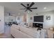 Bright, open-concept living room with a ceiling fan and comfortable furnishings; flows into the dining area at 656 E Mesquite Ave, Apache Junction, AZ 85119