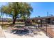 Community barbeque area featuring a grill, picnic tables, mature landscaping, and nearby apartments at 6739 N 16Th St # 14, Phoenix, AZ 85016