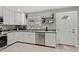 Bright kitchen features modern appliances, gray counters, tile floors, and white cabinets at 6739 N 16Th St # 14, Phoenix, AZ 85016
