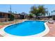 Community pool with crystal clear blue water, lounge chairs, and nearby views of the surrounding area at 6739 N 16Th St # 14, Phoenix, AZ 85016