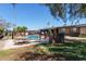 Outdoor community area with fenced pool, picnic tables, brick grill and grassy area on a sunny day at 6739 N 16Th St # 14, Phoenix, AZ 85016