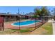 Community pool featuring beautiful blue water with mountain views and trees beyond the secure fence at 6739 N 16Th St # 14, Phoenix, AZ 85016