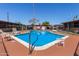 Outdoor community pool with ladder, lounge chairs, and clearly-posted pool rules for resident safety at 6739 N 16Th St # 14, Phoenix, AZ 85016