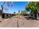 Street view with symmetrical apartments, mature trees and well-maintained landscaping at 6739 N 16Th St # 14, Phoenix, AZ 85016